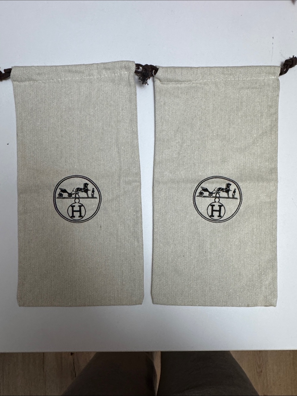 Two Hermes Cream Drawstring Logo Pouch with Black Emblem